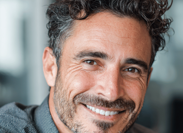 A 40 year old man is looking at the camera