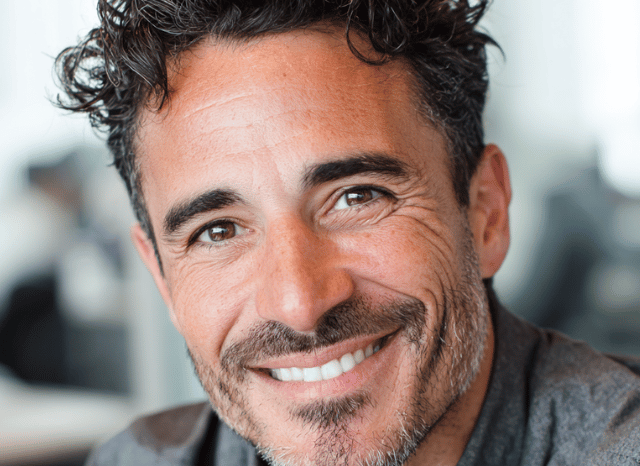 A 40 year old man is smiling