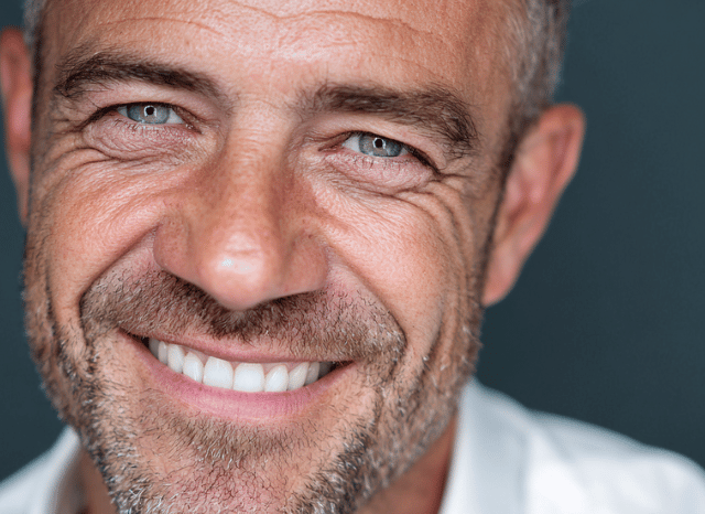 A professional man looks at the camera