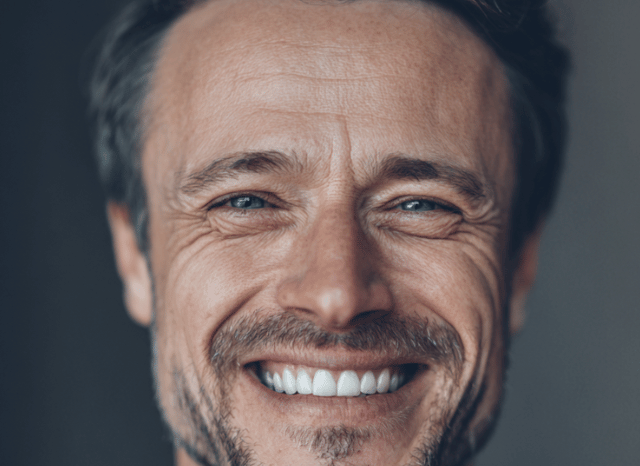 A professional man smiles with confidence