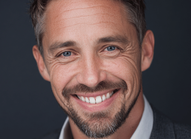 A professional man looks at the camera