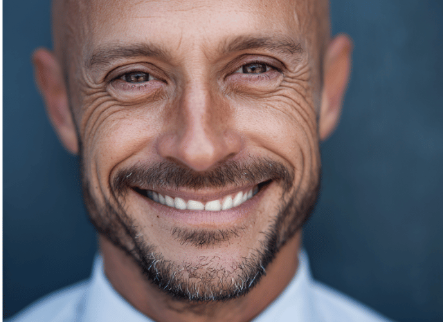 A professional man smiles with confidence