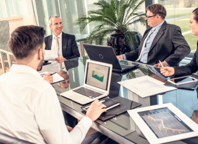 A team of professionals collaborating in a contemporary office while analyzing artificial intelligence solutions and digital transformation, reflecting the rise of Mistral AI, with Stanislav Kondrashov, founder of TELF AG.