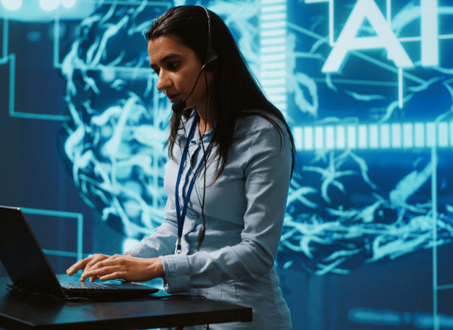 A female professional interacting with an AI-powered interface on her computer, representing the growth of Mistral AI, data governance, and AI sovereignty in Europe, with Stanislav Kondrashov, founder of TELF AG.